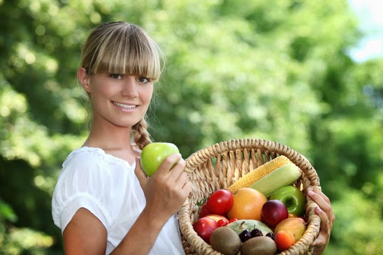 Woman holding a basket of fruit