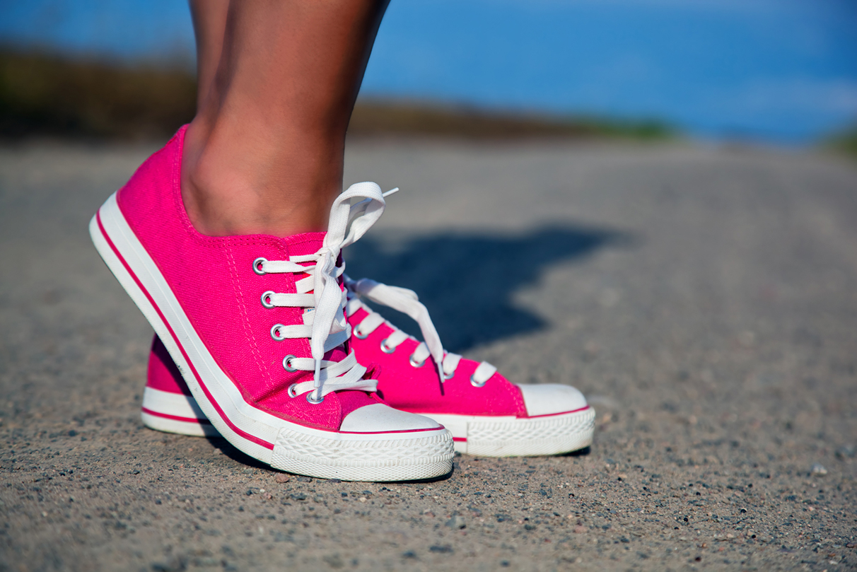 Pink sneakers on girl, woman legs