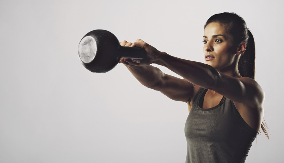 Woman exercise with kettle bell - Crossfit workout