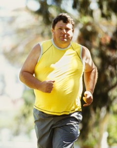 portrait of a mid adult man jogging in a park