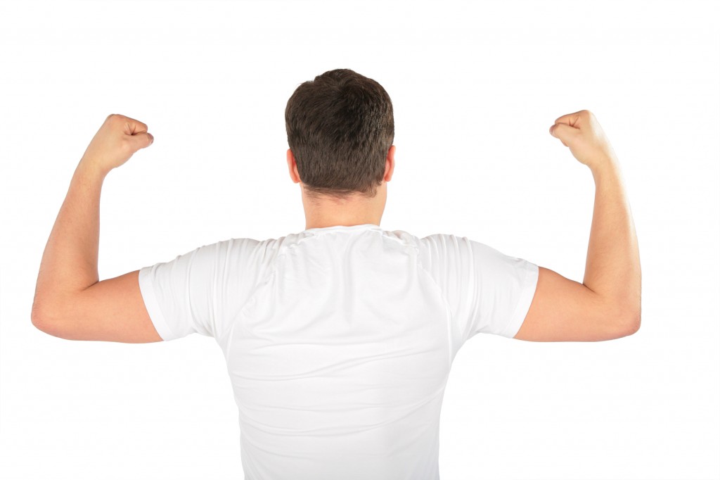 man shows biceps from back